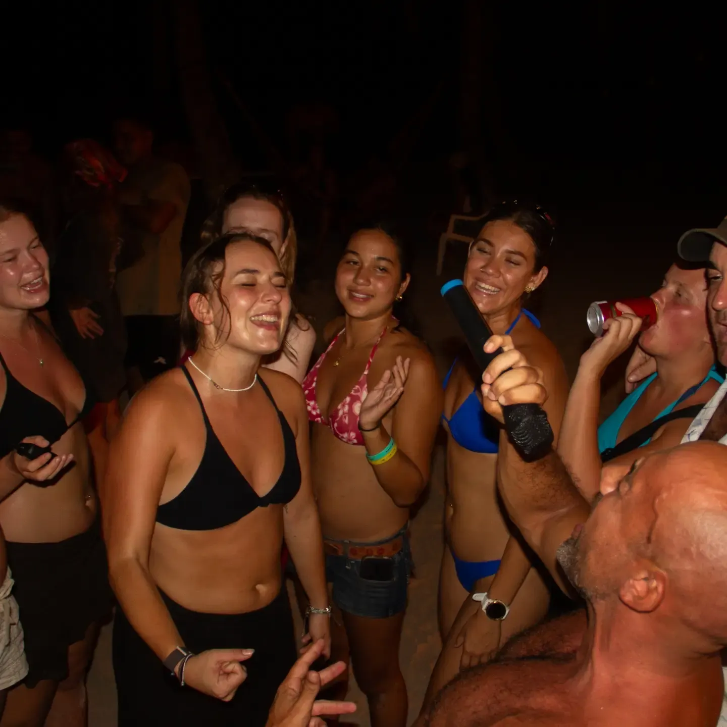 Backpackers dancing at a pirate party night in San Blas