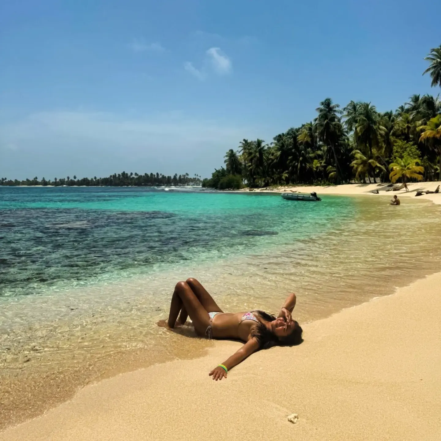 Traveller relaxing on a white sand beach in San Blas, Panama